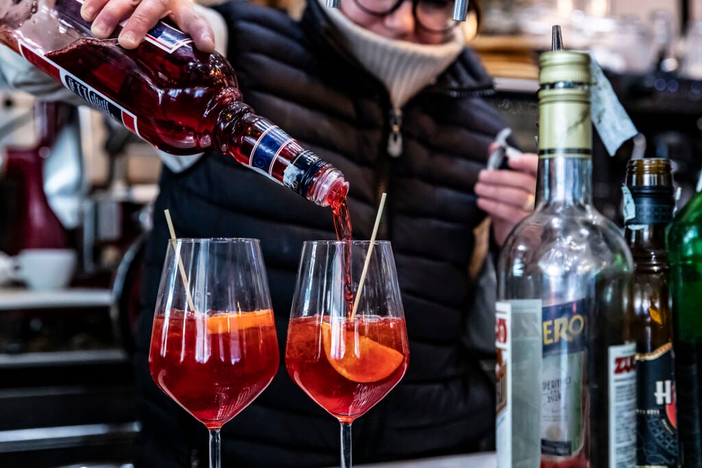 a bartender pours a venetian spritz on an eating europe food tour