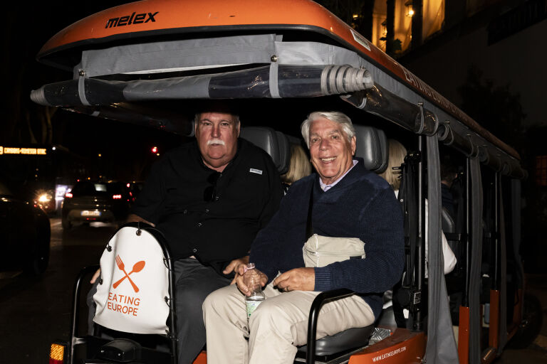 A couple on the back of a golf cart during a tour of Rome