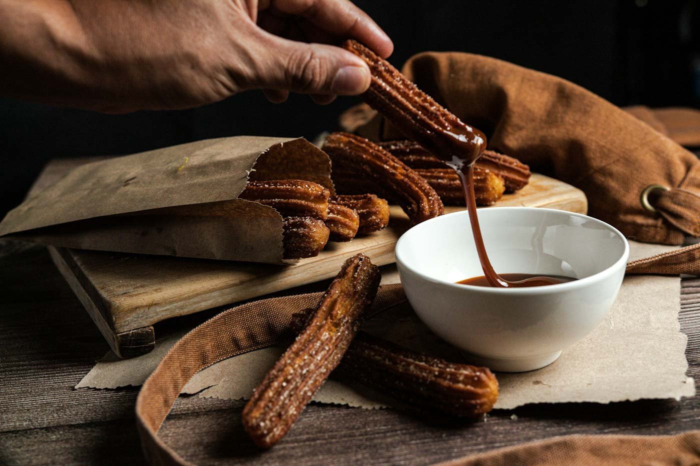 Person_dipping_churros_Seville